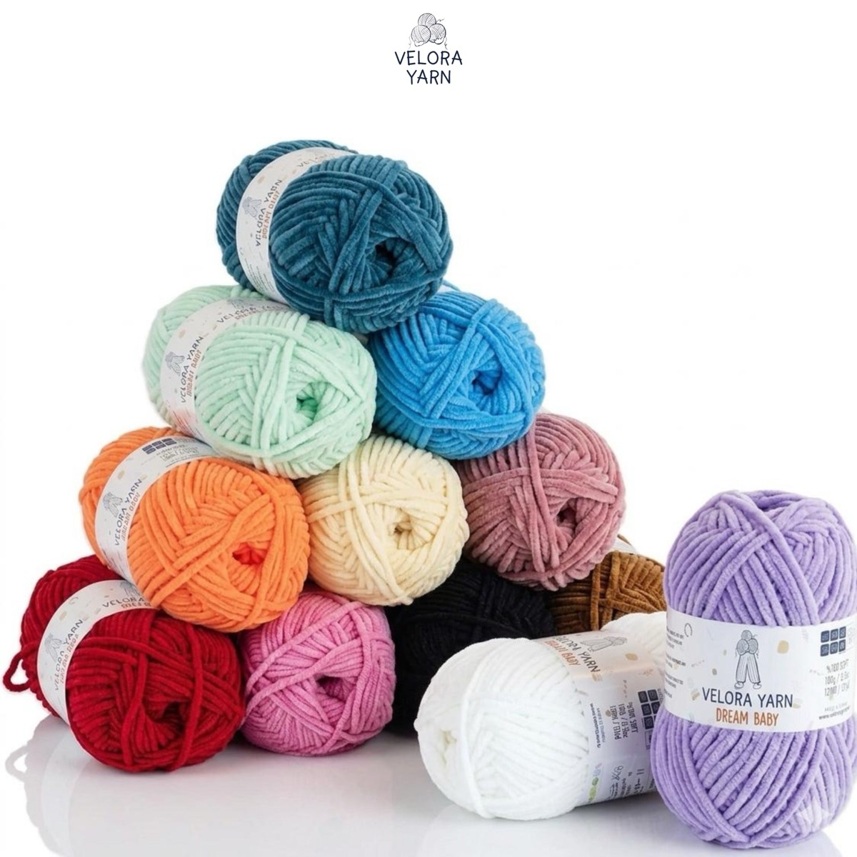 Velora Dream Baby chenille yarn skeins stacked in a rainbow of colours